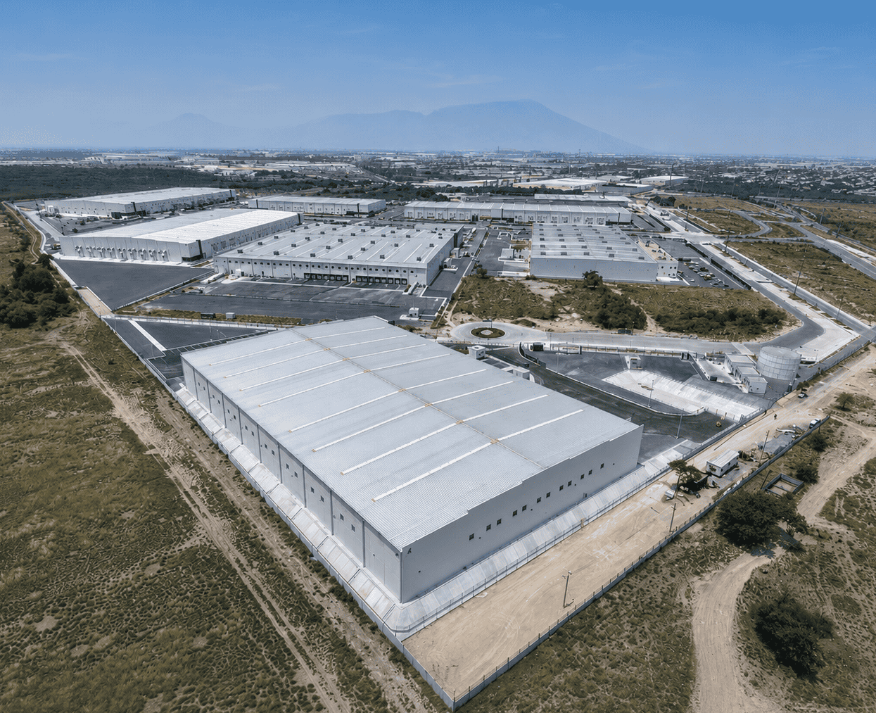 Apodaca II – aerea 1 Aerial view of industrial warehouse rooftops across a Mexico manufacturing corridor, representing corridor-level Class A vacancy and rent data.
